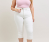 Person wearing white jeans and a pink top on a plain background