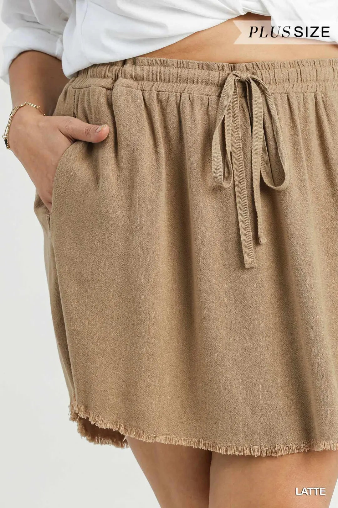 Brown shorts with a tie waist on a white background, labeled 'Plus Size' and 'Latte'.