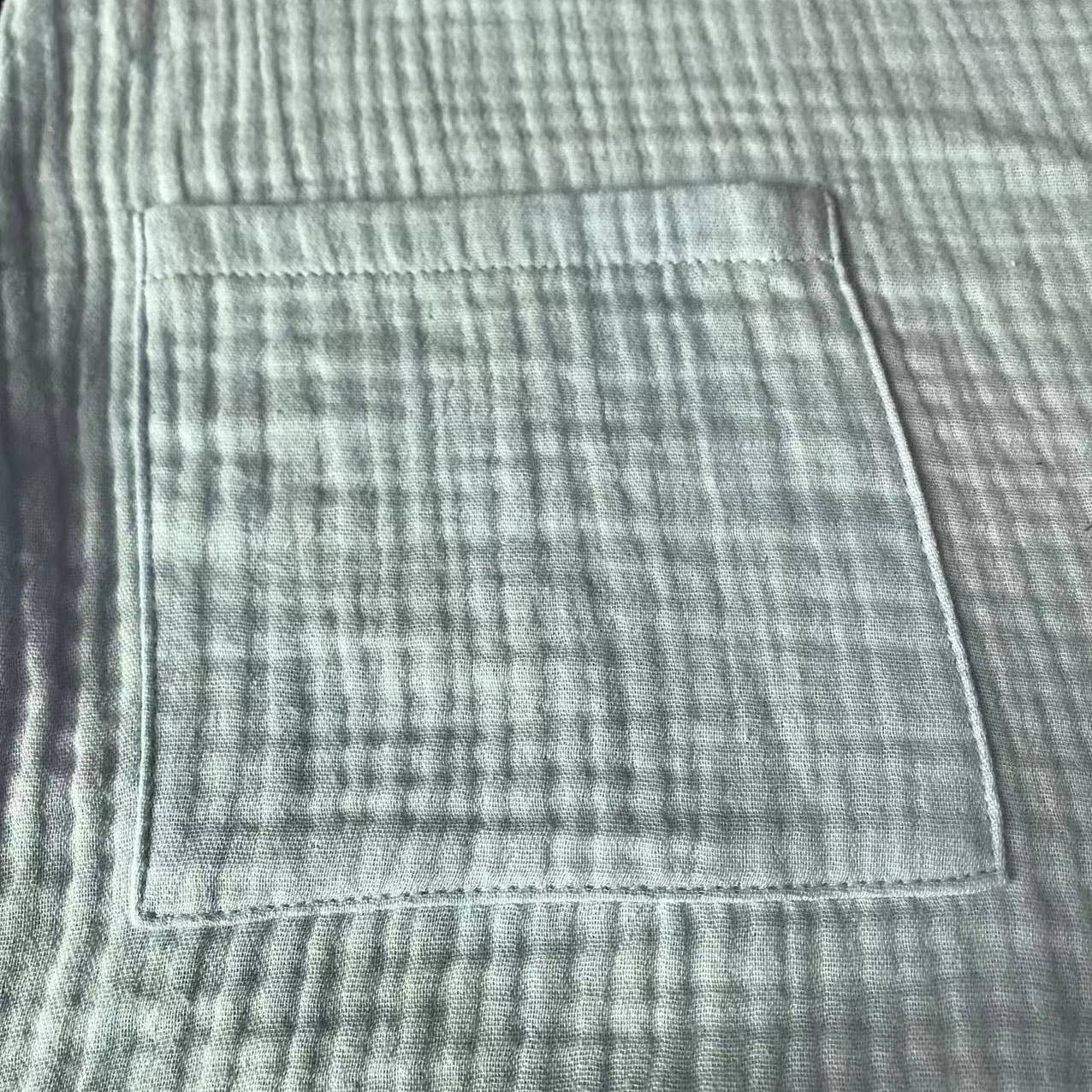 Close-up of a pocket on a textured fabric surface