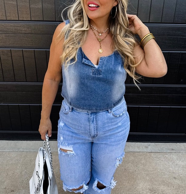 Woman wearing a denim outfit with a black background