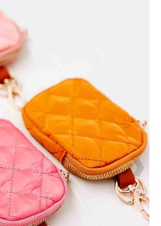 Two quilted keychains, one orange and one pink, on a light background.