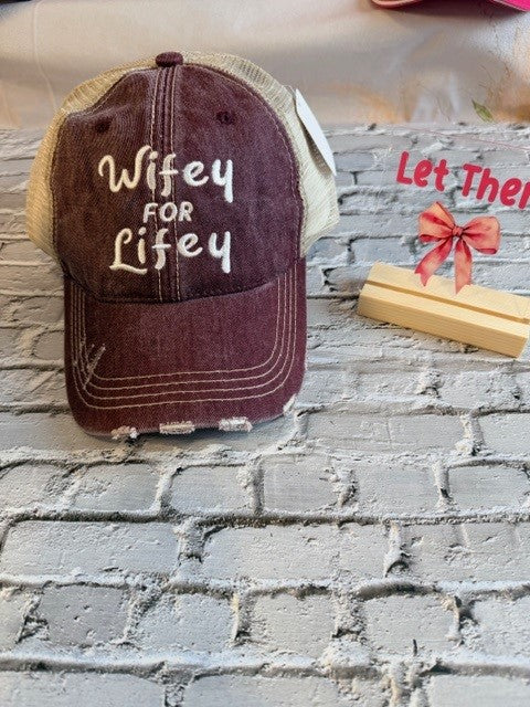Brown cap with 'Wifey FOR Lifey' text on a textured surface