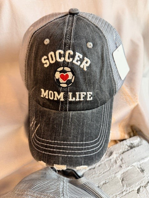 Black distressed cap with 'Soccer Mom Life' text and soccer ball design on a neutral background