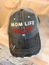 Black distressed cap with 'Mom Life Best Life' text on a wooden surface