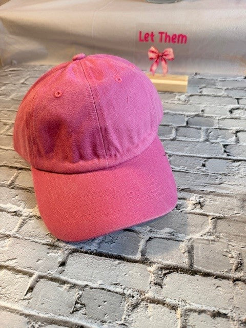 Pink cap on a textured stone surface with a blurred background