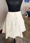 White skirt on a mannequin against a neutral background